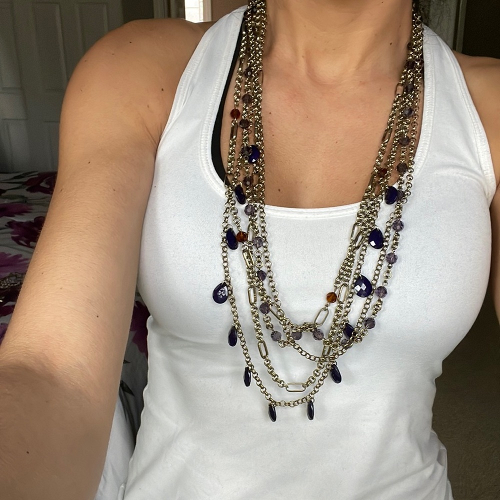 In new condition purple and gold layered necklace
